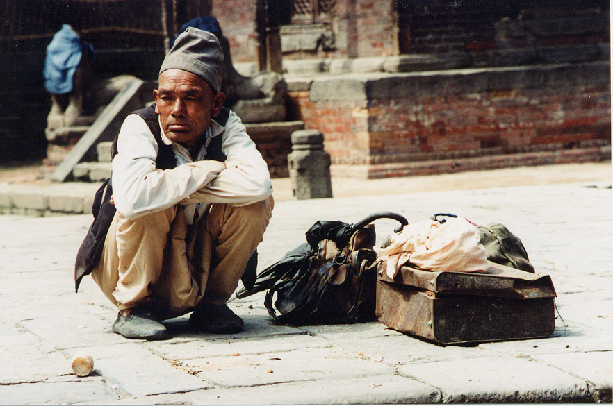 Old Man Squatting With Bags, Katmandu / Nepal