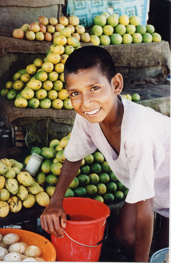 Boy Smiling With Fruit Behind Him / Nepal / Nepali - Click Image to Close